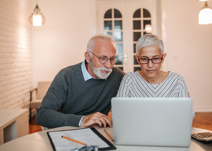 mature couple working on computer